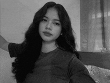 a black and white photo of a young girl with long hair