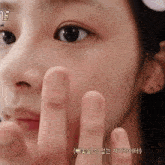 a close up of a woman 's face with the number 15 on the bottom