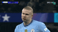a man wearing a blue shirt with the word city on the sleeve