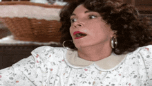 a woman with a surprised look on her face is wearing a white floral dress