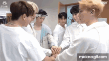 a group of young men are putting their hands together with the words make a gif.com in the lower right corner