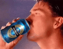 a pixelated image of a man drinking from a can that says heineken