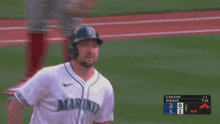 a baseball player wearing a white jersey that says mariner