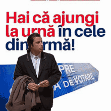 a man in a suit is standing in front of a blue sign that says pre a de votare