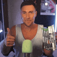 a man holds up a stack of battlefield games and gives a thumbs up