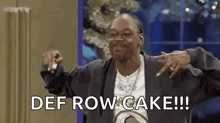 snoop dogg is pointing at the camera and saying def row cake .