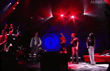 a group of people dancing on a stage with the word alignment in the upper right corner