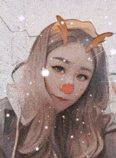 a girl with a reindeer nose and antlers on her head