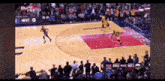 a basketball game is being played in front of a large crowd
