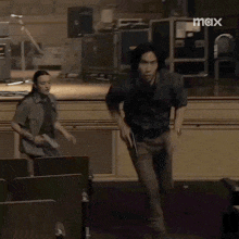 a man running with a gun in a room with max written on the bottom