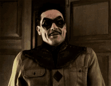 a man with a mustache wearing a mask and a jacket