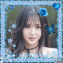 a picture of a girl with a blue rose in her hair and a blue butterfly