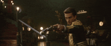 a man in a green and gold uniform is holding a sword