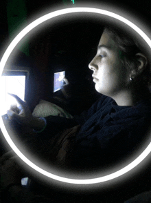 a woman sitting in front of a computer with a white circle around her head