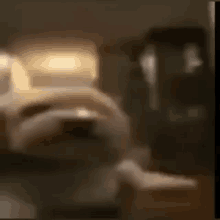 a blurry picture of a room with a table and a chair .