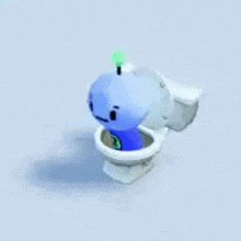 a blue toy is sitting in a toilet with the number 3 on it