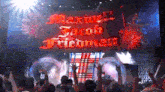 a crowd of people raising their hands in front of a stage that says maxim jacob friedman