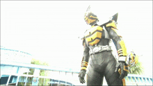 a man in a black and yellow superhero costume with a belt that says ' sd ' on it