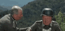 a man in a helmet talks to another man with the words foutez moi la paix written on the bottom