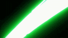 a green light is shining on a black background