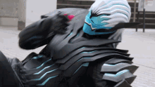 a person in a black and blue costume with a helmet on their head
