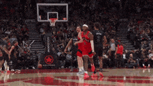 a basketball game is being played in front of a banner for air canada