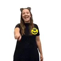 a woman wearing a black shirt with a yellow sticker that says " dancing "
