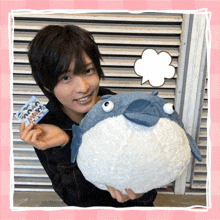 a man holding a stuffed animal with a speech bubble above