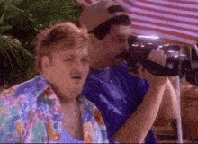 a man taking a picture of another man with a camera