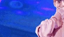 a statue of a man in a pink shirt is standing in front of a blue sky .