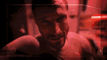 a man with a beard is looking at the camera in a dark room