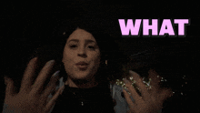 a woman is making a funny face with the word what above her
