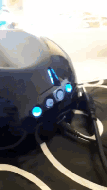 a close up of a black object with blue lights