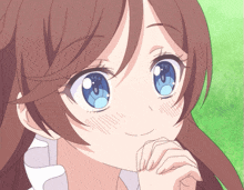 a girl with brown hair and blue eyes is smiling with her hand on her chin