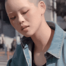 a close up of a woman 's face with her eyes closed