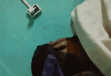 a man is laying on a bed with his head on the floor next to a plug box .