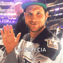 a man wearing a jersey that says hi felecia is waving