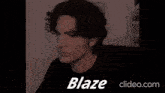 a man in a black shirt is giving a thumbs up and the word blaze is on the screen .