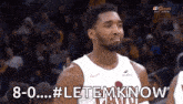 a basketball player is standing in front of a crowd during a game and saying `` let em know '' .