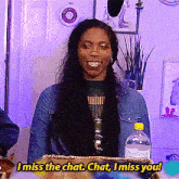 a woman in a denim jacket says i miss the chat