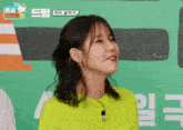 a woman wearing a neon green shirt with a microphone on it