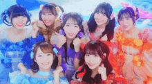 a group of girls are posing for a picture and smiling for the camera