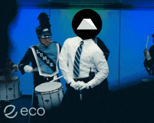 a man in a marching band playing drums with the word eco on the bottom right