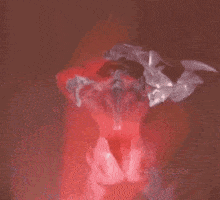 a red light is shining on a person 's face