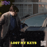 a man holding a helmet next to a car with the words lost my keys