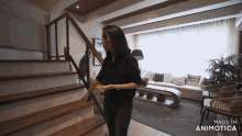 a woman is walking up a set of stairs in a living room made in animatica