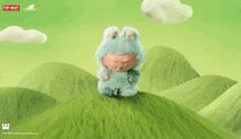 a stuffed animal is sitting on top of a grassy hill with a pop mart logo in the background