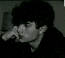 a black and white photo of a man with arabic writing