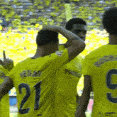 soccer players wearing yellow jerseys with the number 219 on the back