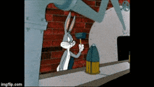 bugs bunny is holding a hammer in front of a brick wall